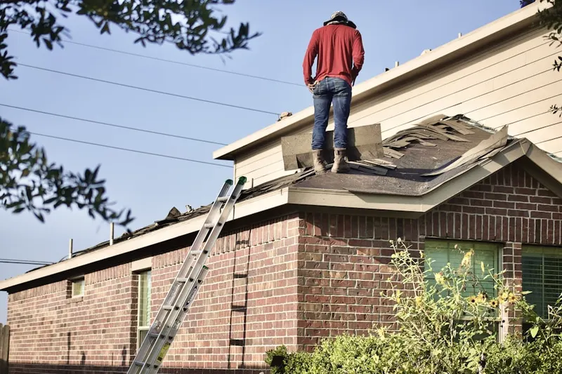 Professional roofer working on a residential roof in Energy Park